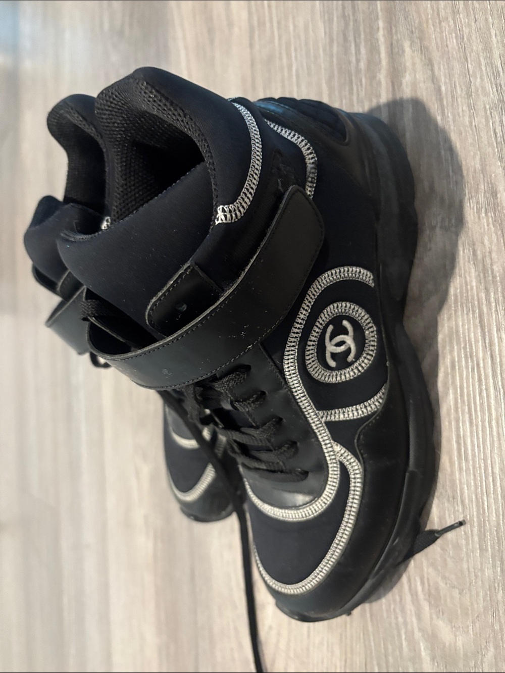CHANEL Black High-Top Sneakers with Silver Detailing